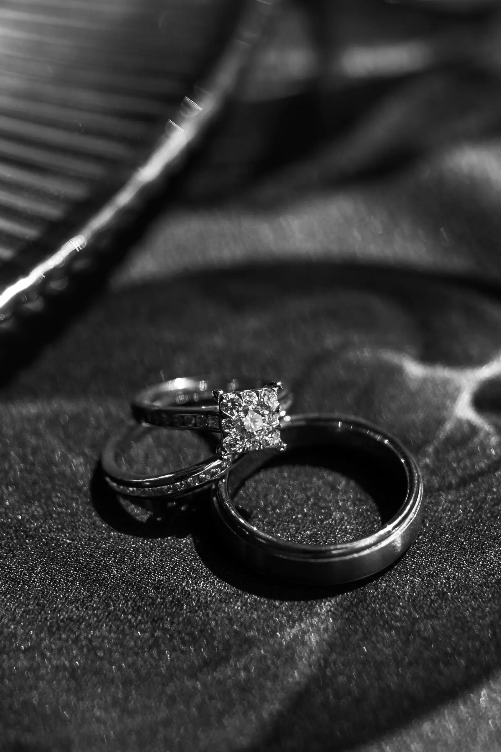 Wedding rings resting on dark fabric, macro detail