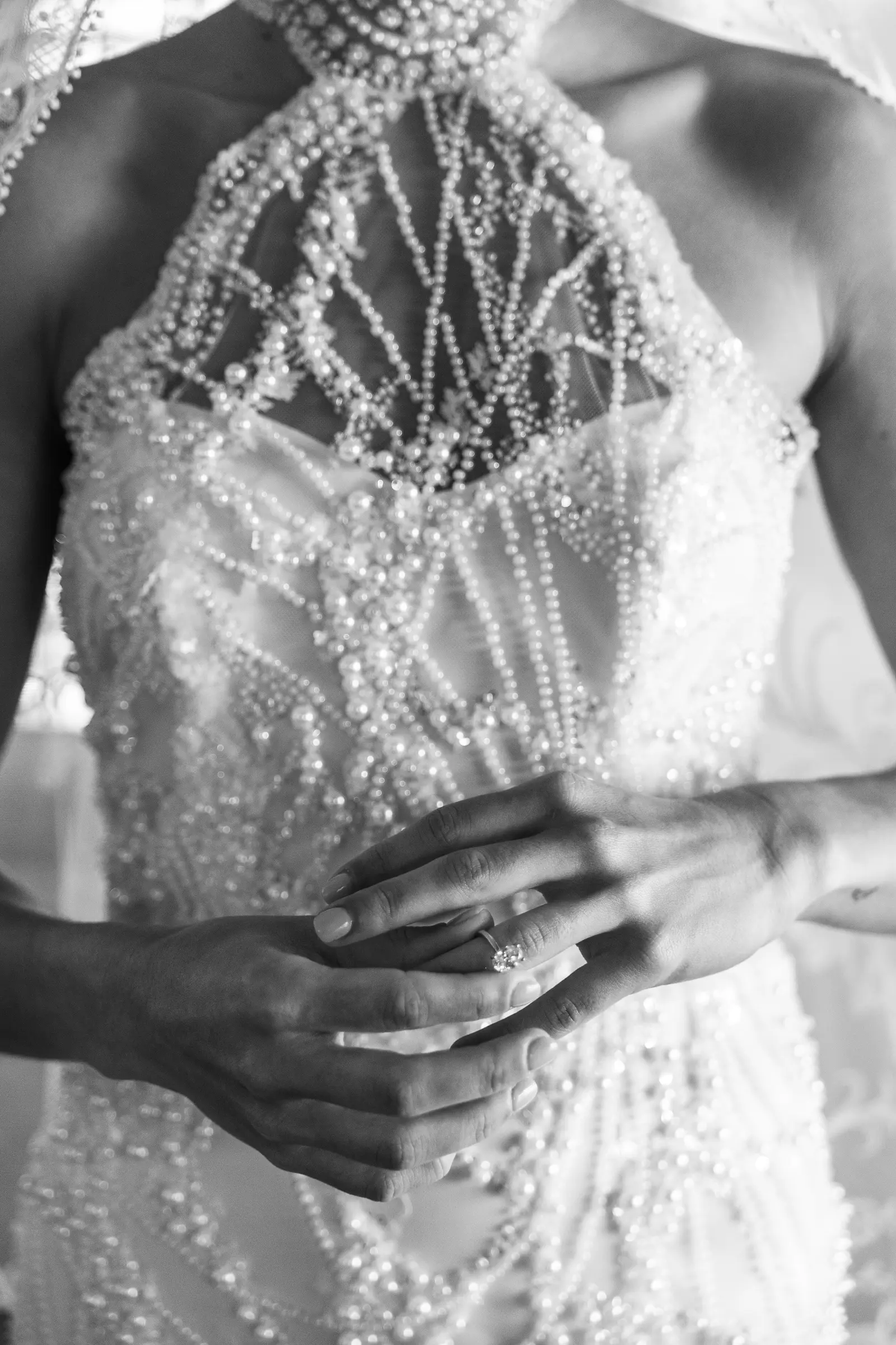 Close-up of wedding dress detail on the bride's torso