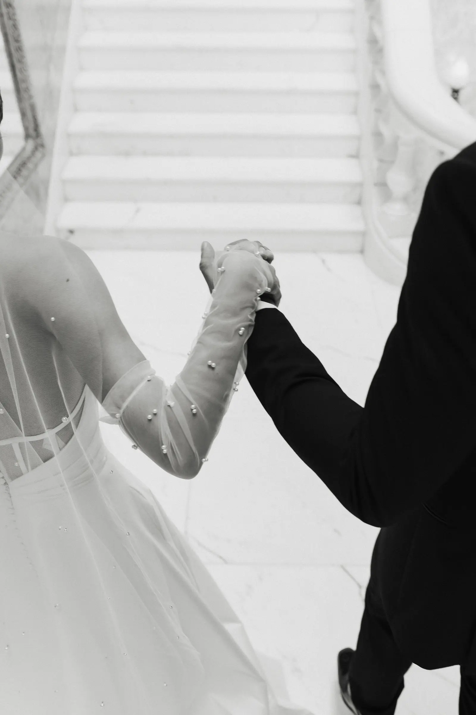 Bride and groom dancing together on a staircase