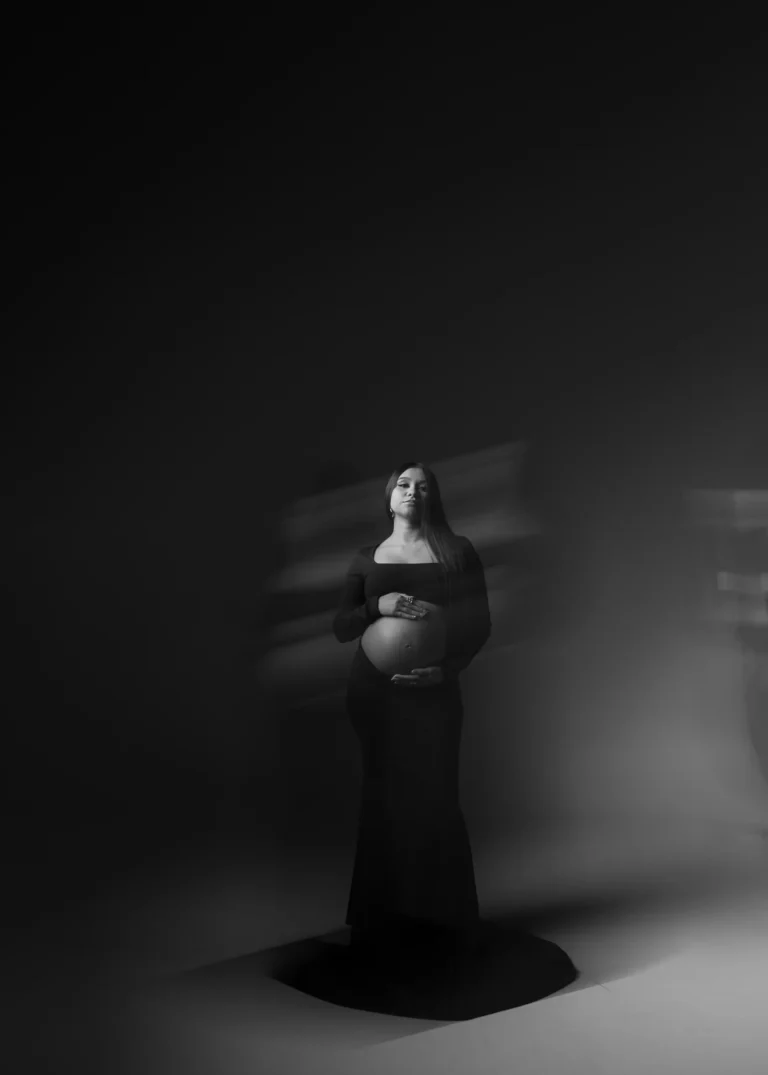 Artistic motion-blur portrait of a pregnant woman in a flowing gown