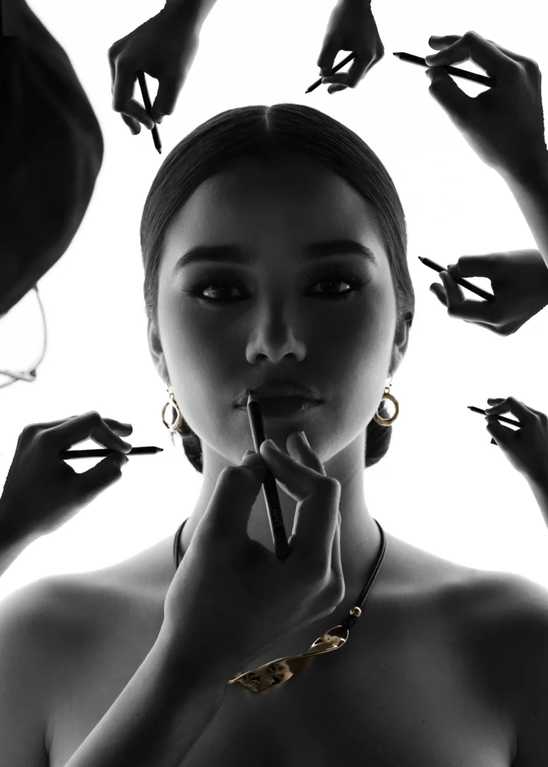 Black-and-white artistic portrait of a woman with hands framing her face